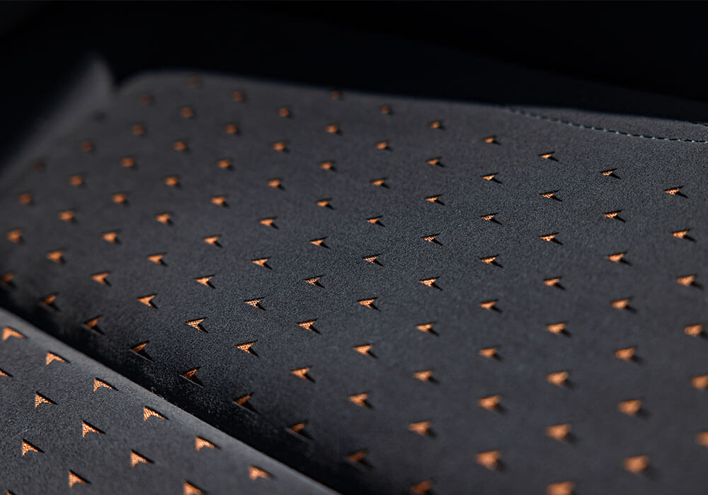 Macro photo of black and orange vehicle fabric upholstery