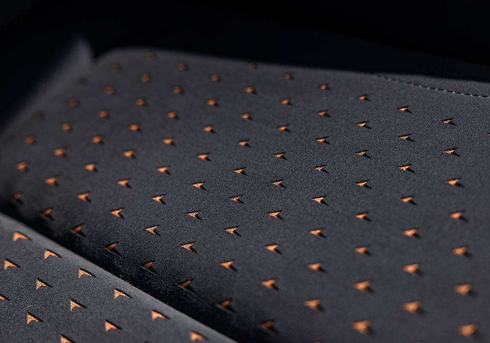 Detail photo of a copper accented perferrated fabric