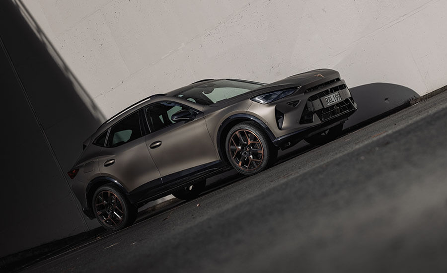 Dutch angle photo of a bronze cupra SUV