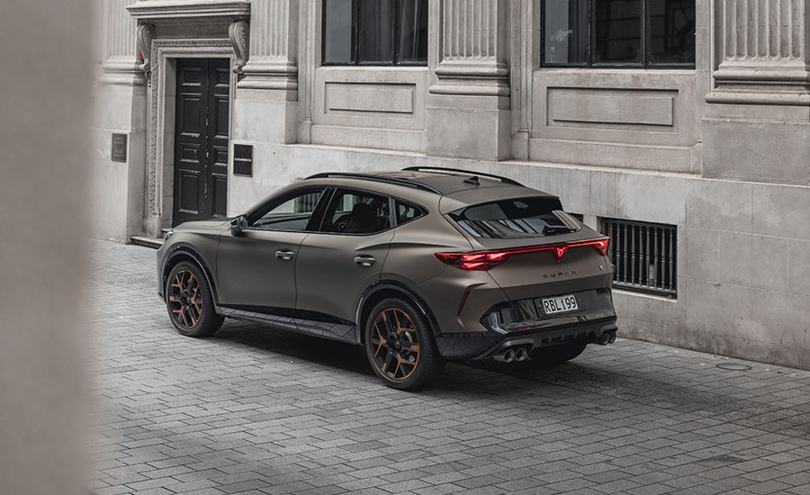 Rear angle of a bronze CUPRA formentor on a European street