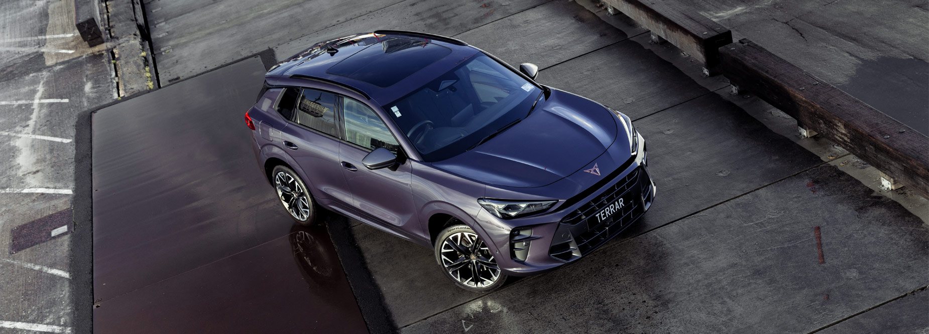 High angle photo of a dark purple CUPRA Terramar SUV parked