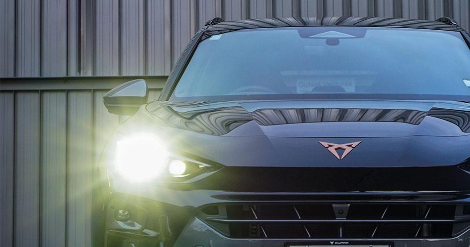 Front of a CUPRA with the headlights on